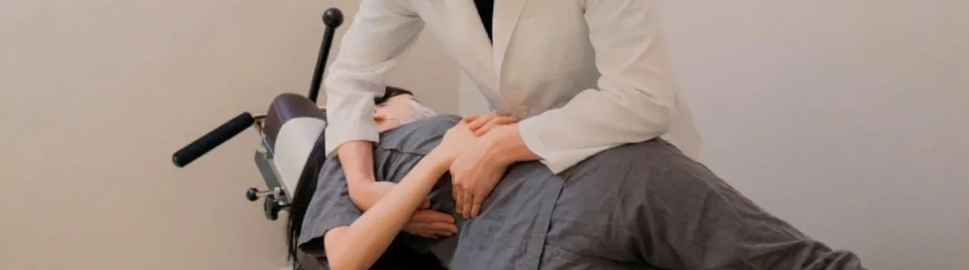 치료대 위에서 추나 요법을 받는 환자와 시술하는 의료진